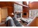 Living room with wooden walls, a stone fireplace, wood flooring, and French doors to the exterior at 8091 C 476B, Bushnell, FL 33513
