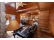 Inviting living room with a stone fireplace, wood walls and floors, and a comfortable leather sofa at 8091 C 476B, Bushnell, FL 33513