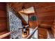 Loft area featuring a stone fireplace, wood walls and floors, and a ceiling fan at 8091 C 476B, Bushnell, FL 33513