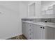 Bathroom featuring double sink vanity with gray cabinets, gray backsplash and wood look flooring at 811 N Swindell #2 Ave, Lakeland, FL 33810