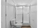 Bathroom featuring a toilet and white shower with sliding glass door and wood look flooring at 811 N Swindell #2 Ave, Lakeland, FL 33810