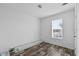 Empty bedroom with window, neutral walls, and wood look flooring with molding on floor at 811 N Swindell #2 Ave, Lakeland, FL 33810