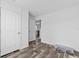 Bedroom with neutral walls and wood look flooring and view into the hallway at 811 N Swindell #2 Ave, Lakeland, FL 33810
