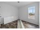 Empty bedroom with window, neutral walls, wood look flooring and doors laying on floor at 811 N Swindell #2 Ave, Lakeland, FL 33810