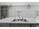 Kitchen island with stainless steel sink and faucet, and pendant lighting at 811 N Swindell #2 Ave, Lakeland, FL 33810