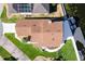 An overhead shot showing a home with a brown roof, a boat dock and waterfront access at 830 Palm Harbor Ct, Leesburg, FL 34748