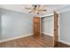 Bedroom featuring wood floors, closet, and a ceiling fan with lighting at 830 Palm Harbor Ct, Leesburg, FL 34748