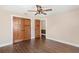 Bedroom with closet and wood-look floors at 830 Palm Harbor Ct, Leesburg, FL 34748