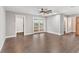 Bright bedroom with wood-look floors, French doors, and ample natural light at 830 Palm Harbor Ct, Leesburg, FL 34748