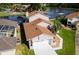 An aerial view of a waterfront home with a well-manicured lawn and lake access at 830 Palm Harbor Ct, Leesburg, FL 34748