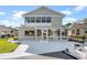 The home's exterior has a screened-in porch, fenced yard, concrete patio, and dock at 830 Palm Harbor Ct, Leesburg, FL 34748