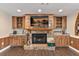 Close up of brick fireplace with custom wood cabinets and shelving, providing a cozy focal point at 830 Palm Harbor Ct, Leesburg, FL 34748