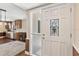 Inviting foyer with hardwood flooring and an open view into the kitchen with wood cabinets at 830 Palm Harbor Ct, Leesburg, FL 34748