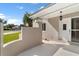 Home exterior with a white front door, an elegant hanging lantern, and meticulous landscaping at 830 Palm Harbor Ct, Leesburg, FL 34748