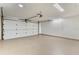 Spacious garage with white walls, sealed floor, and an automatic garage door at 830 Palm Harbor Ct, Leesburg, FL 34748