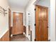 Hallway with wood flooring, wainscotting, and wooden doors to closet and bathroom at 830 Palm Harbor Ct, Leesburg, FL 34748