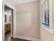 Hallway with tile floor leading to the bathroom at 830 Palm Harbor Ct, Leesburg, FL 34748