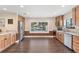 Bright kitchen featuring wood cabinets, stainless appliances, and a large window with a lake view at 830 Palm Harbor Ct, Leesburg, FL 34748