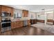 Bright, updated kitchen offers ample storage, wood cabinets, stainless appliances, and seamlessly connects to the dining area at 830 Palm Harbor Ct, Leesburg, FL 34748