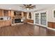 Spacious living room featuring a brick fireplace, custom wood cabinets, and luxury vinyl plank flooring at 830 Palm Harbor Ct, Leesburg, FL 34748