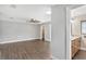 Main bedroom with wood-look floors and en-suite bathroom at 830 Palm Harbor Ct, Leesburg, FL 34748