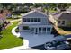 Rear exterior of home featuring an enclosed patio, spacious yard, and boat dock at 830 Palm Harbor Ct, Leesburg, FL 34748