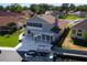 Home featuring an enclosed patio, spacious yard, and private boat dock on the canal at 830 Palm Harbor Ct, Leesburg, FL 34748