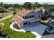 Home featuring an enclosed patio, expansive yard, and canal access at 830 Palm Harbor Ct, Leesburg, FL 34748