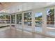 Sunroom featuring panoramic views of the lake, with access to the dock at 830 Palm Harbor Ct, Leesburg, FL 34748