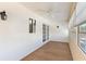 Bright sunroom with wood floors, white walls, and many windows at 830 Palm Harbor Ct, Leesburg, FL 34748