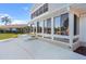 Sunroom with many windows overlooking the water and patio at 830 Palm Harbor Ct, Leesburg, FL 34748