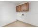 Utility room with cabinets and connections for washer and dryer at 830 Palm Harbor Ct, Leesburg, FL 34748
