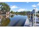 Picturesque water view with boat lifts, reflecting a serene and peaceful neighborhood at 830 Palm Harbor Ct, Leesburg, FL 34748