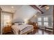 Serene bedroom with wood beam details, hardwood floors, and ample natural light at 908 N Tremain St, Mount Dora, FL 32757