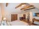 Inviting bedroom with hardwood floors, decorative ceiling beams, and a cozy, neutral aesthetic at 908 N Tremain St, Mount Dora, FL 32757