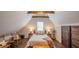 Comfortable bedroom with wooden beams, sloped ceilings, and a quaint seating area at 908 N Tremain St, Mount Dora, FL 32757