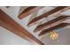 Close-up of wooden beams with stained glass and decorative lighting, adding character to the home at 908 N Tremain St, Mount Dora, FL 32757