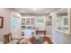 Bright dining area with built-in hutch, wooden floors, and decorative stained glass window at 908 N Tremain St, Mount Dora, FL 32757