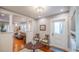 Inviting entryway featuring hardwood floors, decorative lighting, and seamless flow into the living area at 908 N Tremain St, Mount Dora, FL 32757
