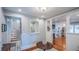 Open entryway with hardwood flooring, stylish decor, and easy access to multiple living areas at 908 N Tremain St, Mount Dora, FL 32757