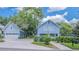 Daytime shot of a charming home with a detached garage, a paved driveway, and a manicured front yard at 908 N Tremain St, Mount Dora, FL 32757