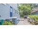 Exterior of home showcases a blue door with access to a brick patio, an outdoor grill, and comfortable seating at 908 N Tremain St, Mount Dora, FL 32757