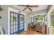 Inviting covered front porch with comfortable seating, ceiling fans, and a view of the neighborhood at 908 N Tremain St, Mount Dora, FL 32757