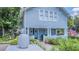 Inviting covered front porch with double doors, classic columns, and a decorative pineapple at 908 N Tremain St, Mount Dora, FL 32757