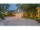 Detached garage featuring ample parking space and architectural details complementing the main house at 908 N Tremain St, Mount Dora, FL 32757