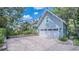 Detached garage with a multi-paned door and a paved area, offering ample parking at 908 N Tremain St, Mount Dora, FL 32757