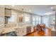 Charming kitchen featuring stainless appliances, a farmhouse sink, and easy access to the dining area at 908 N Tremain St, Mount Dora, FL 32757
