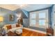 Cozy living room area with hardwood floors, and a neutral sofa set beneath a sloped ceiling at 908 N Tremain St, Mount Dora, FL 32757
