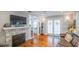 Cozy living room with hardwood floors, fireplace, and French doors, perfect for entertaining at 908 N Tremain St, Mount Dora, FL 32757