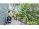 Back patio features a grill, outdoor seating, and lush landscaping, perfect for outdoor gatherings at 908 N Tremain St, Mount Dora, FL 32757